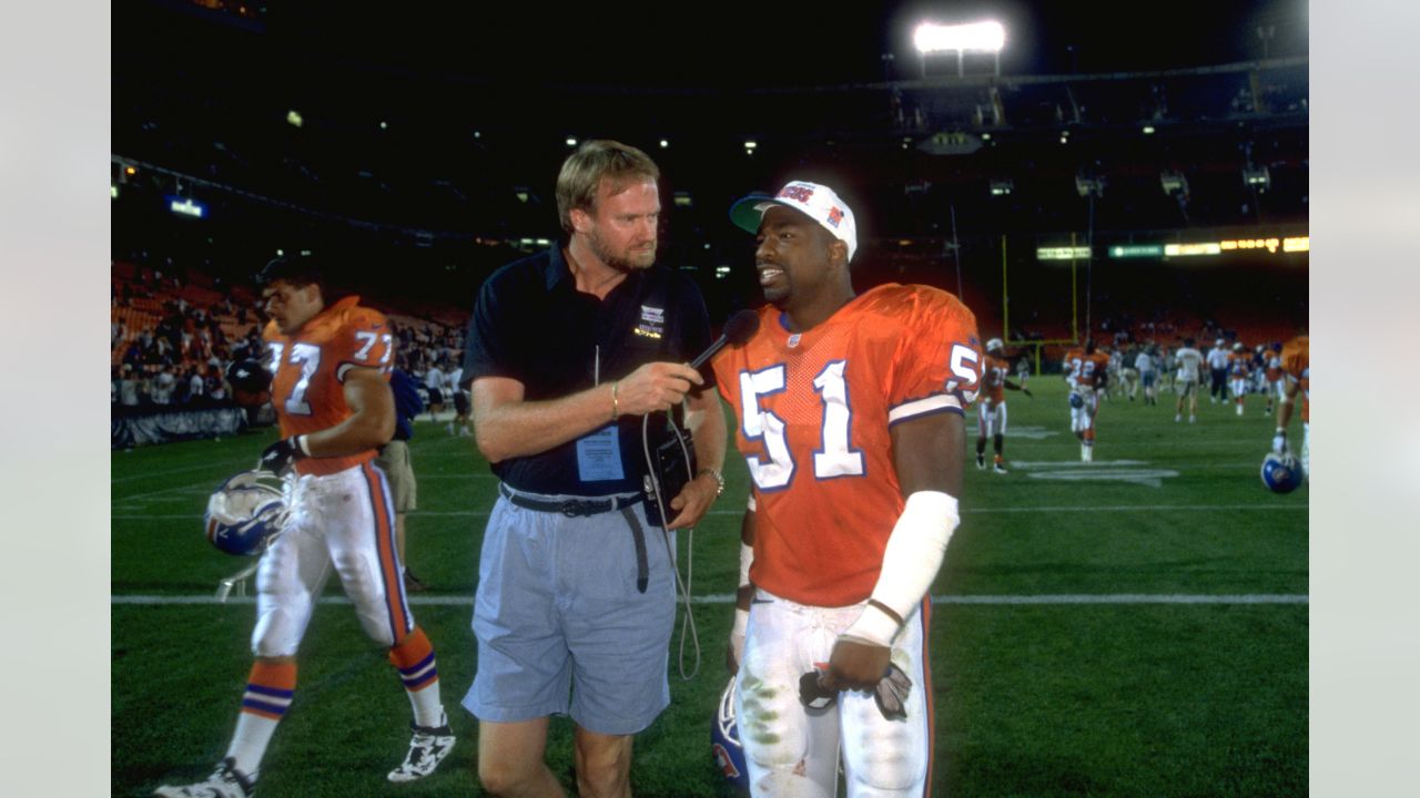 Denver Broncos linebacker Keith Burns jokes with teammates as the