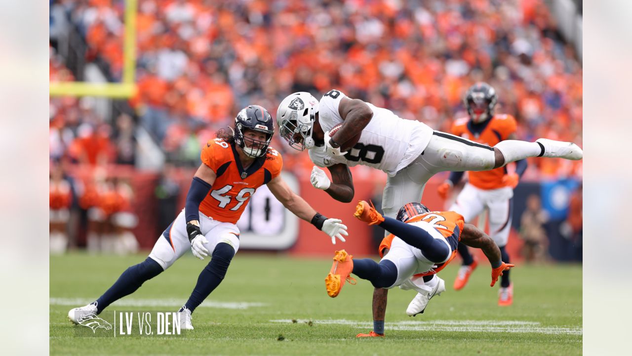 Denver Broncos vs. Las Vegas Raiders. NFL Game. American Football League  match. Silhouette of professional player celebrate touch down. Screen in  back Stock Photo - Alamy