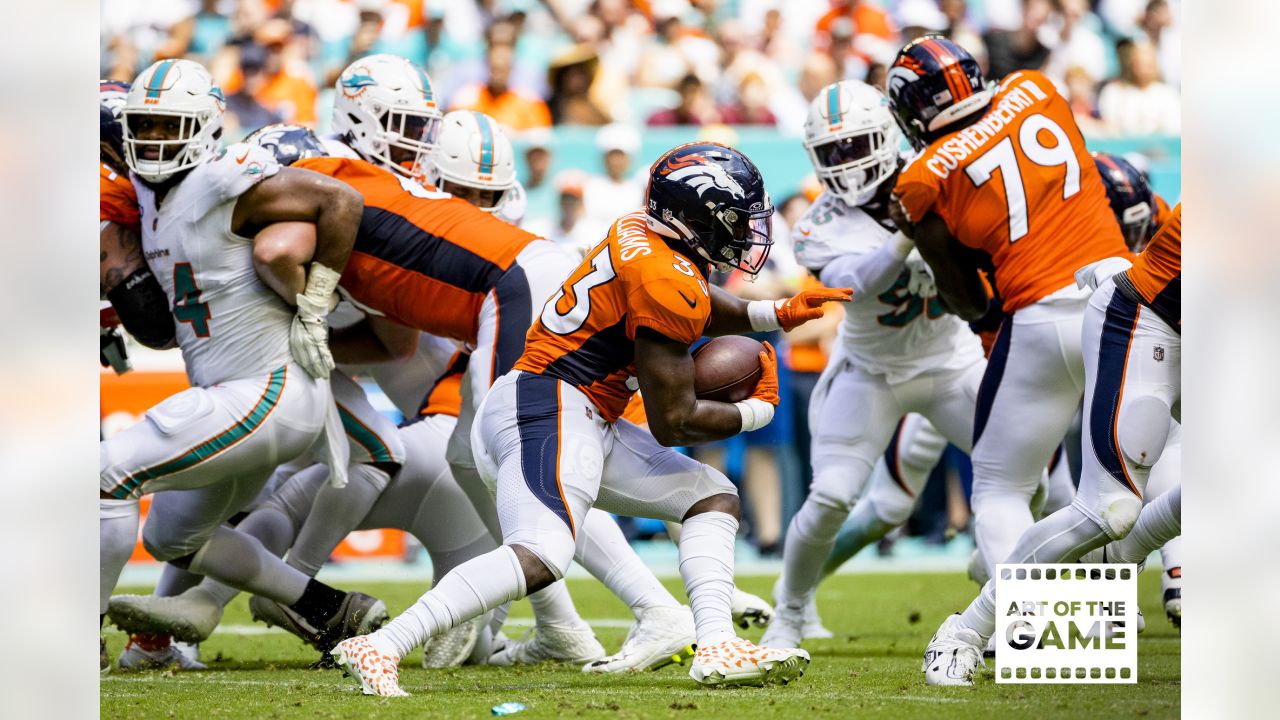 Denver Broncos wide receiver Brandon Johnson (89) runs with the ball past  Miami Dolphins cornerback Kader