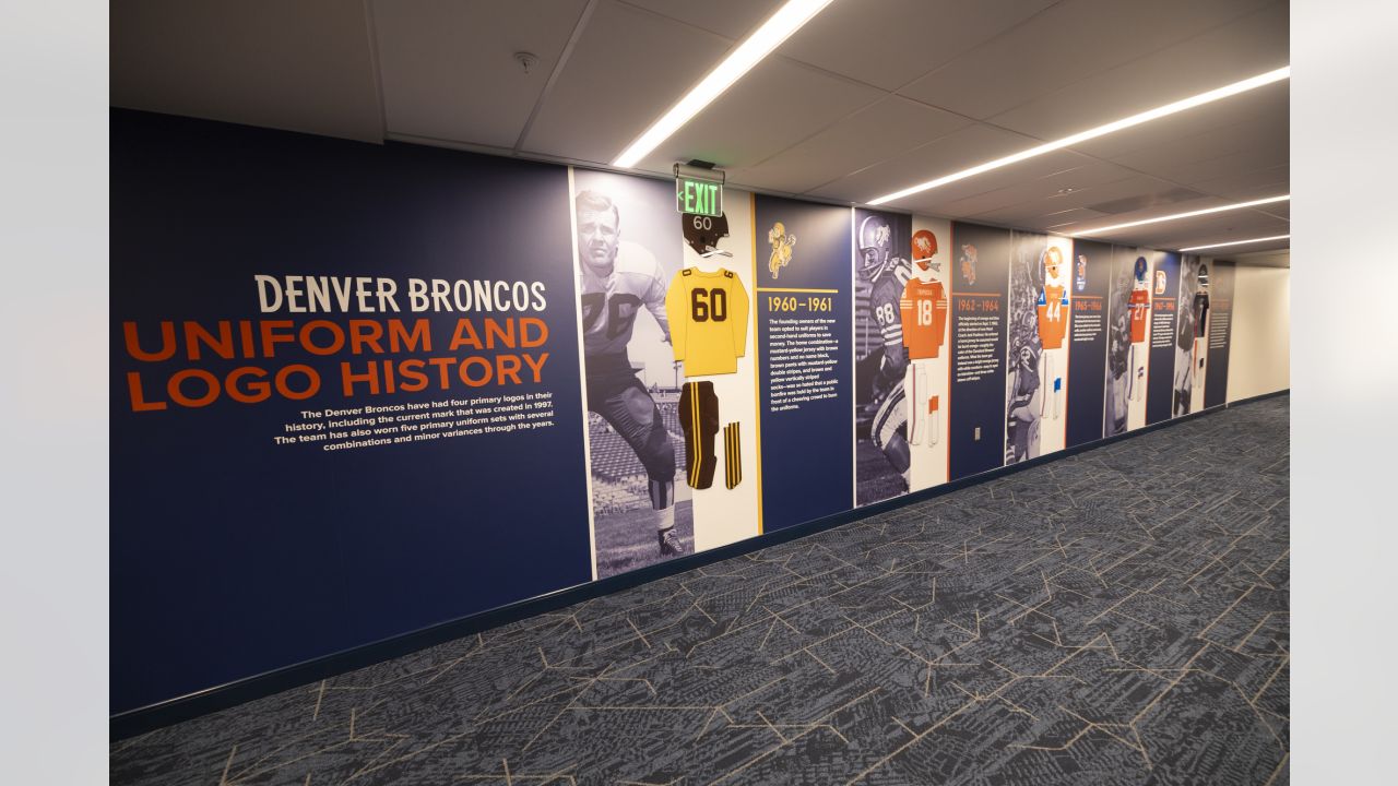 Painting a Broncos Hall of Fame wall at the Empower Field on the