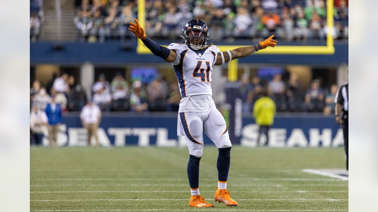 Denver Broncos players run on the field led by McTelvin Agim (95), Marquiss  Spencer (51), Justin Strnad (40), Jamar Johnson (41) with other following  to start an NFL football preseason game against