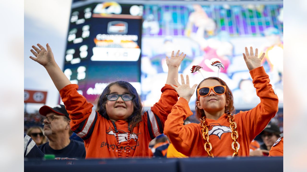 A small group of Denver Broncos fans line up in front of the