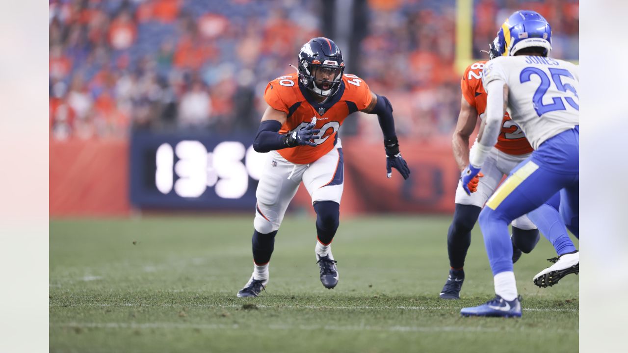 Denver Broncos players run on the field led by McTelvin Agim (95), Marquiss  Spencer (51), Justin Strnad (40), Jamar Johnson (41) with other following  to start an NFL football preseason game against