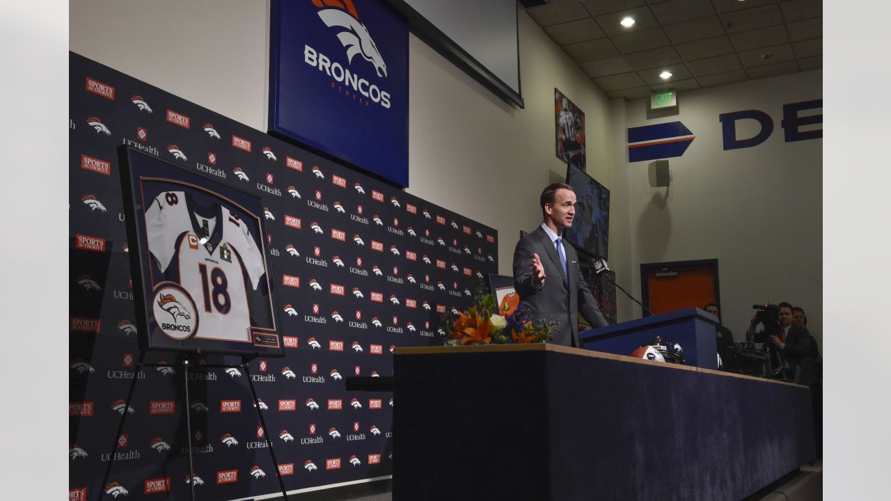 Why is Peyton Manning wearing his helmet in the training room? 