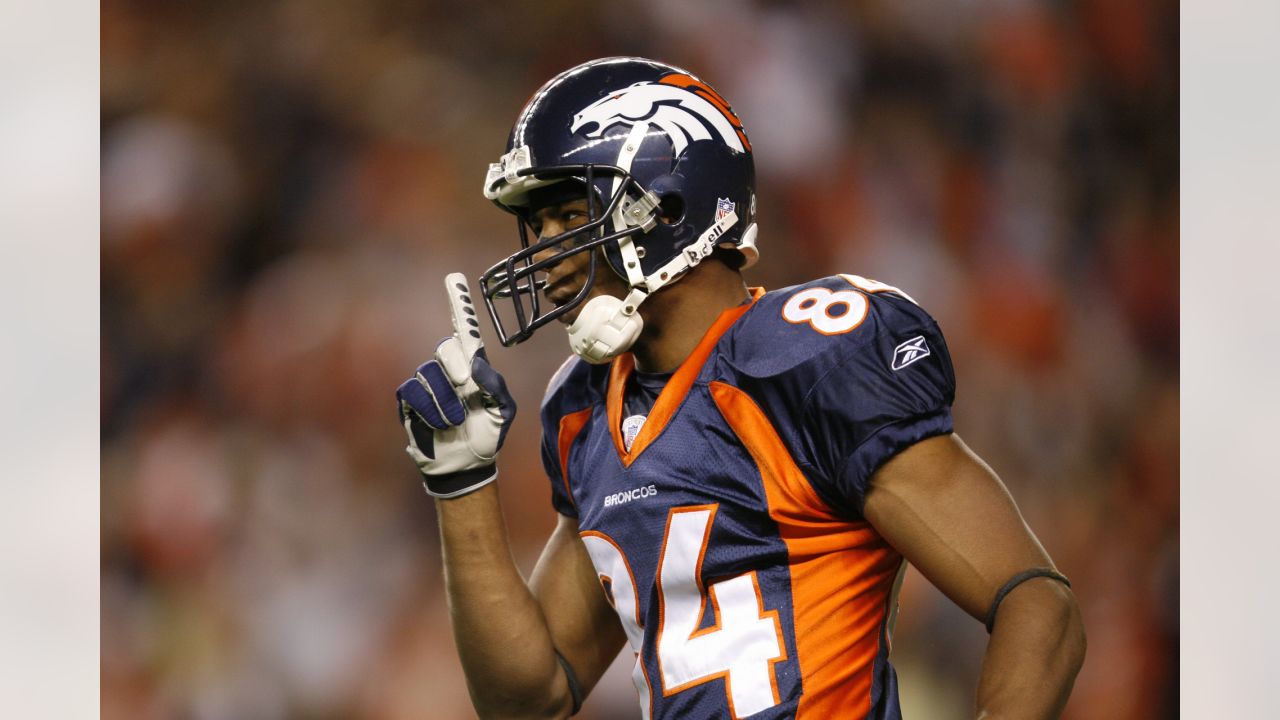 Denver Broncos wide receiver Emmanuel Sanders (10) catches a pass against  Houston Texans safety Kendrick Lewis during the first quarter at Sports  Authority Field at Mile High on August 23, 2014 in