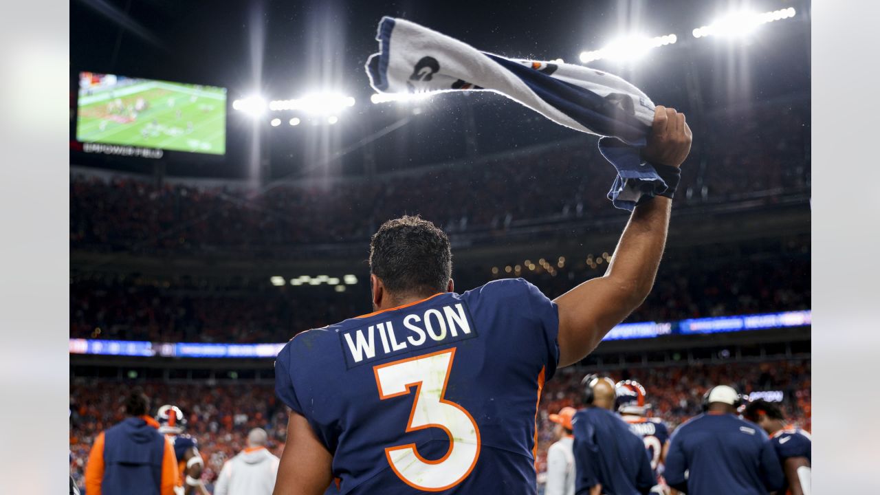 A Seattle Seahawks fan wearing a Russell Wilson jersey waves a towel next  to a Denver Broncos fan wearing a Russell Wilson jersey before an NFL  football game, Monday, Sept. 12, 2022