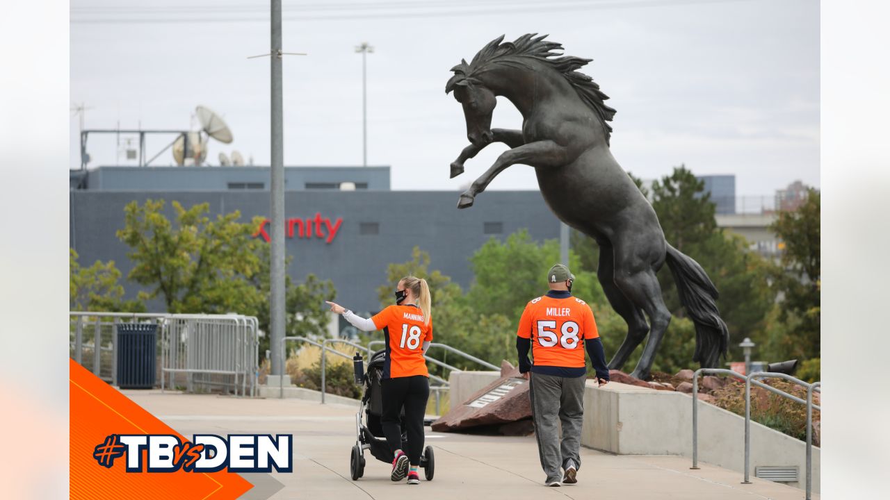 Fans explore the Mile High Monument in the north parking lot Sunday, Sept.  18, 2016, before the start of the Broncos-Colts game at Sports Authority  Field at Mile High in Denver. The