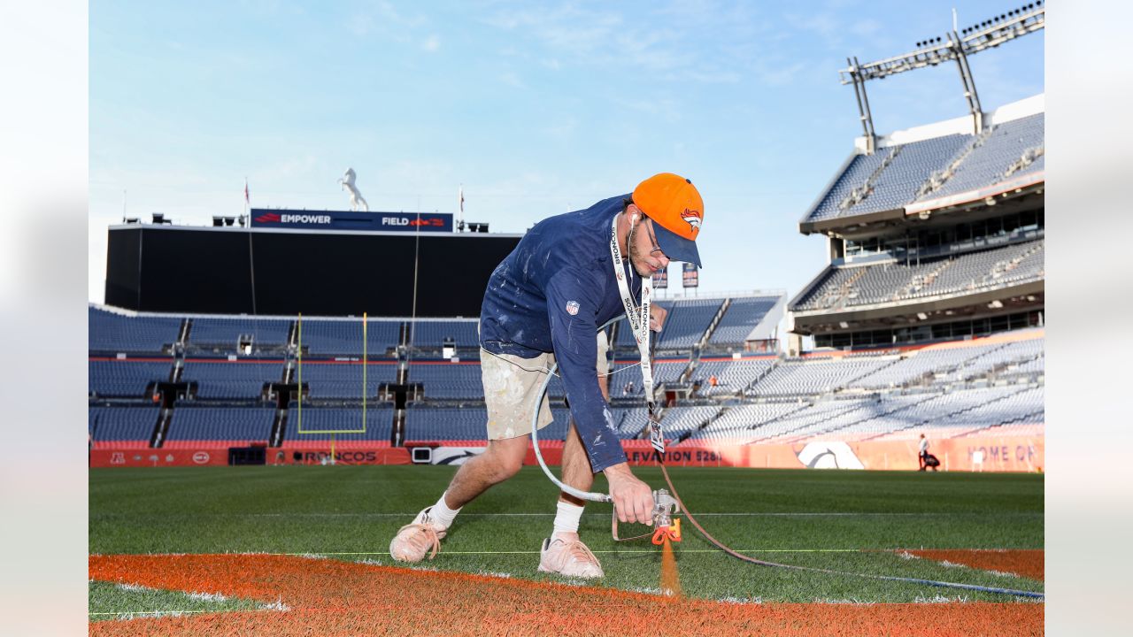 Painting a Broncos Hall of Fame wall at the Empower Field on the