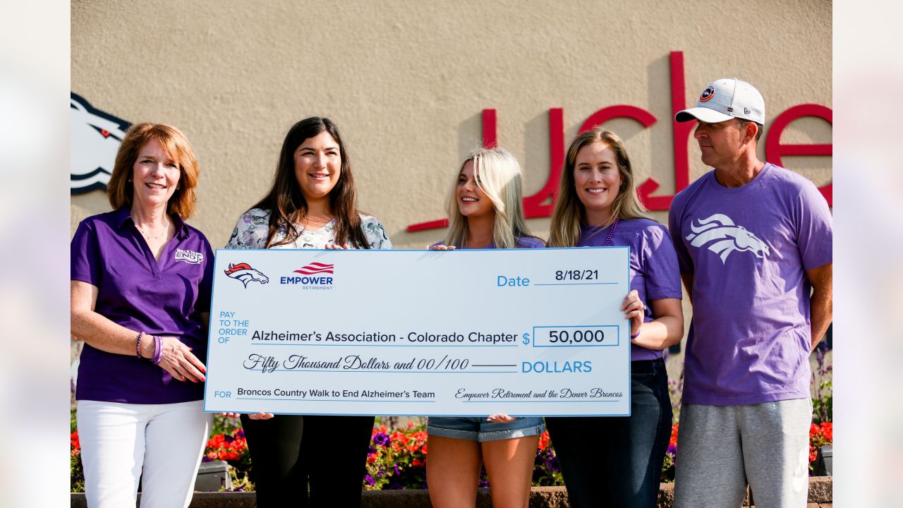 Brittany Bowlen, center, chats with George Paton, right, general manager of  the Denver Broncos, and Nancy Thompson during a news conference to raise  awareness of Alzheimer's disease outside the team's headquarters Wednesday