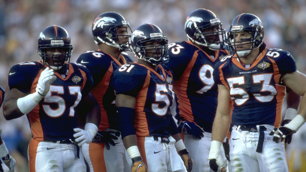 Denver Broncos lineman Dwayne Carswell, right, catches his first