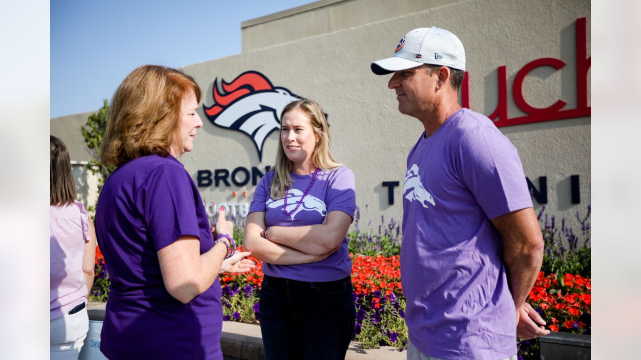 Brittany Bowlen, center, chats with George Paton, right, general manager of  the Denver Broncos, and Nancy Thompson during a news conference to raise  awareness of Alzheimer's disease outside the team's headquarters Wednesday