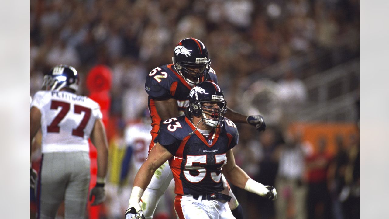 Denver Broncos linebacker Bill Romanowski celebrates after