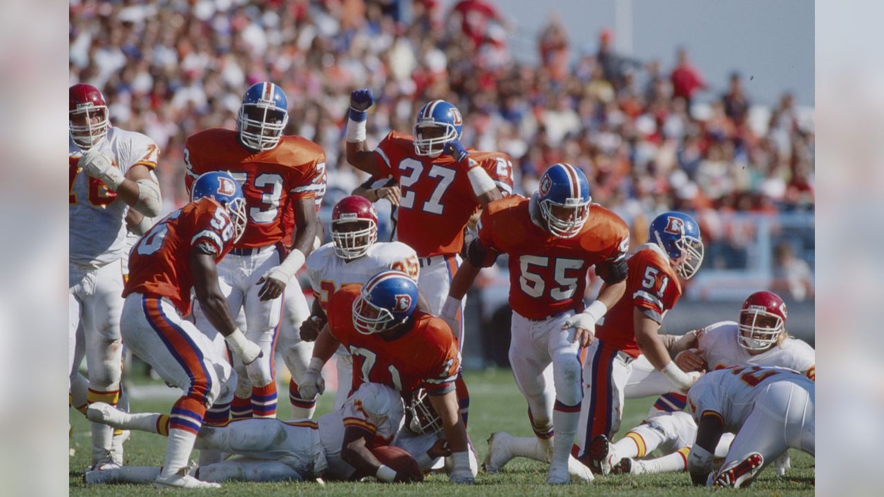 Kansas City Chiefs safety Greg Wesley tore the helmet off of Denver Broncos  running back Mike Bell in the fourth quarter at Invesco Field at Mile High  in Denver, Colorado, Sunday, September