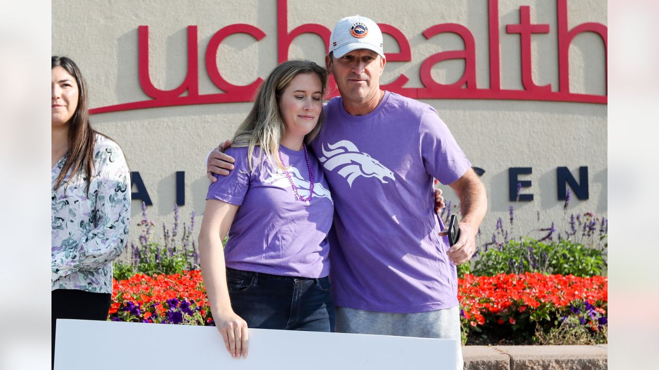 Brittany Bowlen, center, chats with George Paton, right, general manager of  the Denver Broncos, and Nancy Thompson during a news conference to raise  awareness of Alzheimer's disease outside the team's headquarters Wednesday