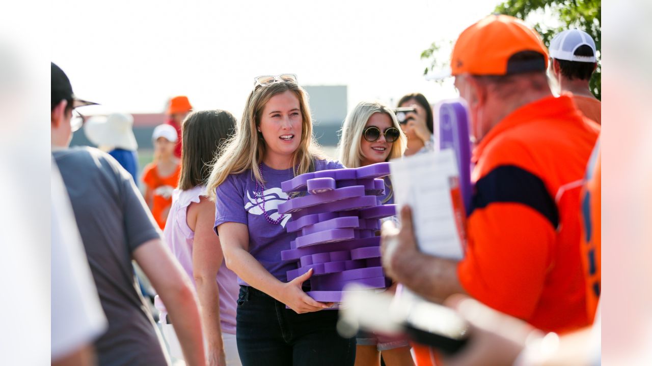 Brittany Bowlen, center, chats with George Paton, right, general manager of  the Denver Broncos, and Nancy Thompson during a news conference to raise  awareness of Alzheimer's disease outside the team's headquarters Wednesday