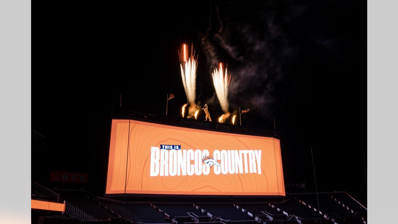 Painting a Broncos Hall of Fame wall at the Empower Field on the