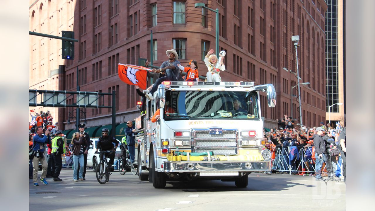 John Bowlen, left, and his mother, Annabelle, the wife of Denver Broncos  owner Pat Bowlen, acknowledge the crowd at a rally following a parade  through downtown Tuesday, Feb. 9, 2016 in Denver.