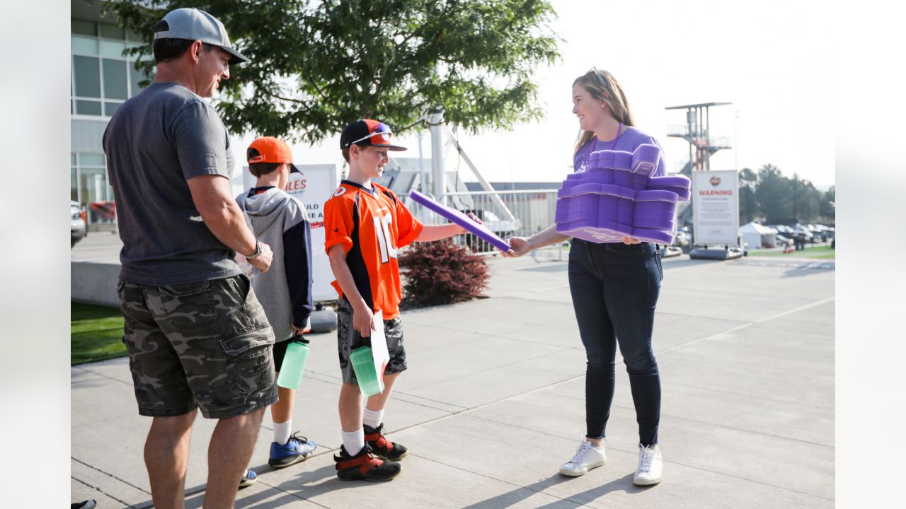 Brittany Bowlen, center, chats with George Paton, right, general manager of  the Denver Broncos, and Nancy Thompson during a news conference to raise  awareness of Alzheimer's disease outside the team's headquarters Wednesday