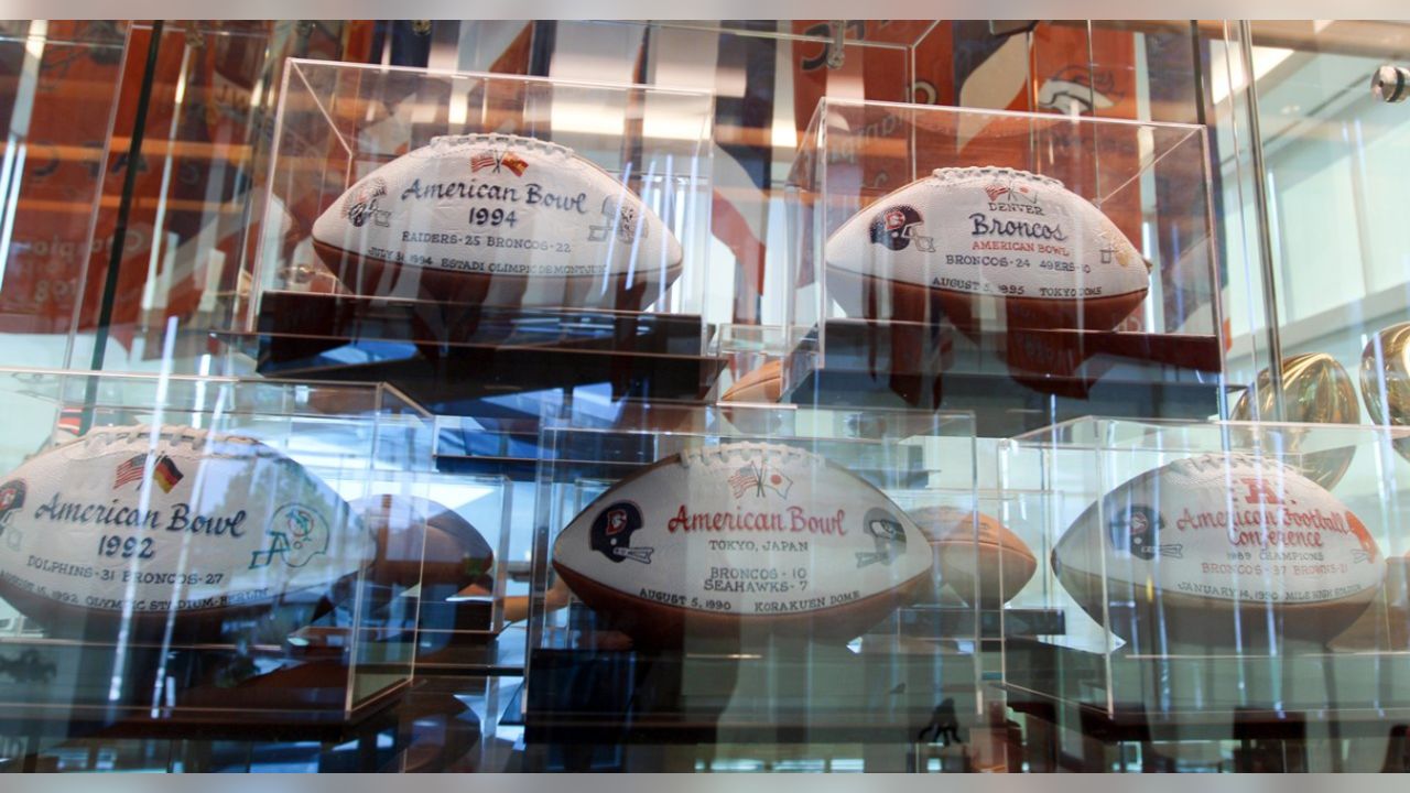 Denver Broncos professional american football club, silhouette of NFL  trophy, logo of the club in background Stock Photo - Alamy