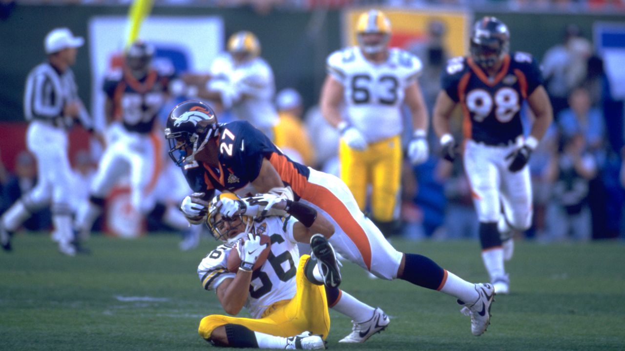 Denver Broncos lineman Dwayne Carswell, right, catches his first