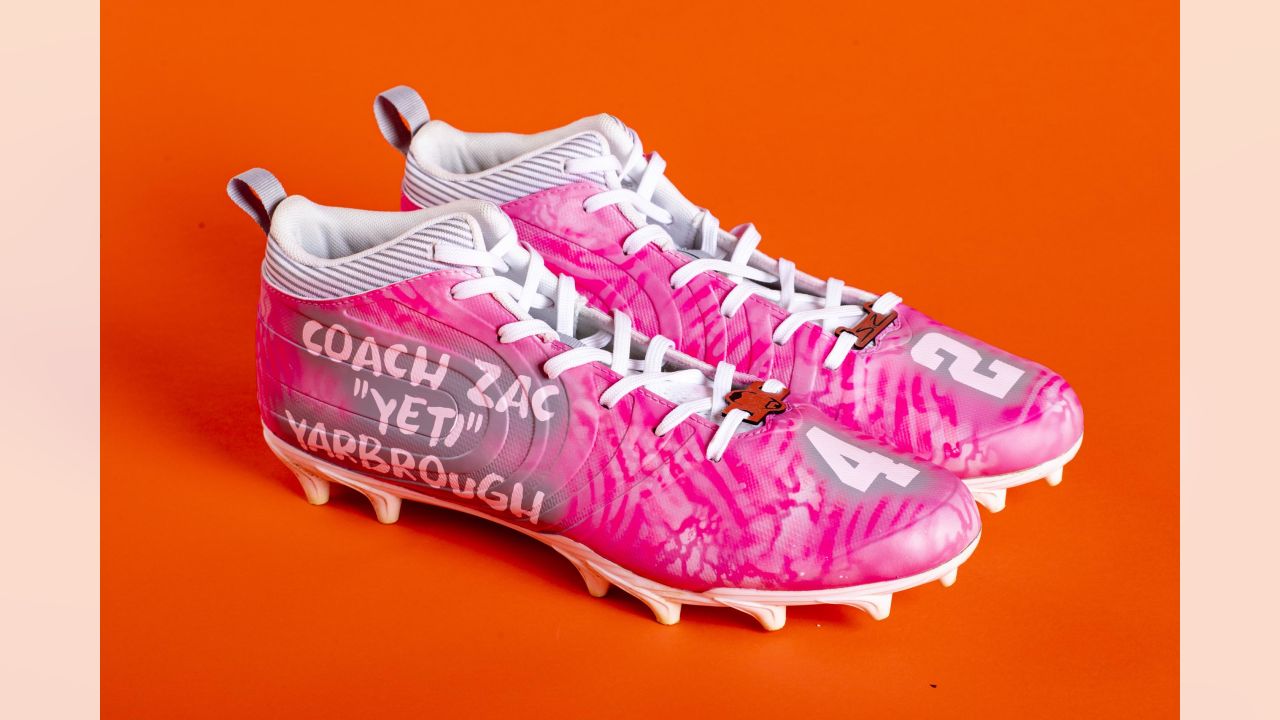 A closeup of cleats customized with Louis Vuitton designs, worn by