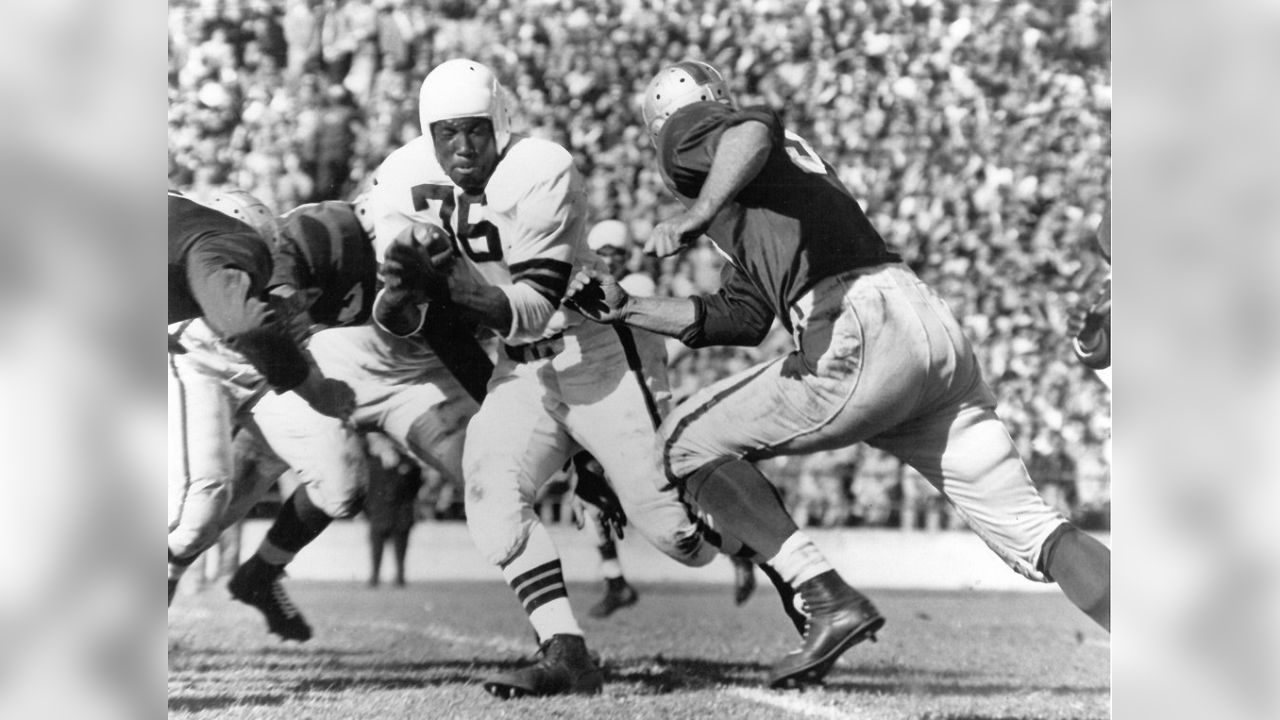 FILE - In this Dec. 19, 1948, file photo, Cleveland Browns fullback Marion  Motley, right, stands with coach Paul Brown after a football game against  Buffalo in Cleveland. Brown never saw color