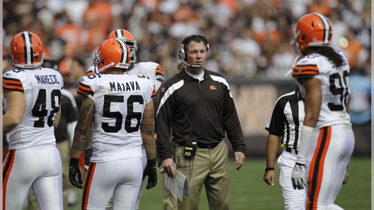 Cleveland Browns coach Pat Shurmur walks off the field with a game ball  after the Browns beat the Miami Dolphins 17-16 in an NFL football game  Sunday, Sept. 25, 2011, in Cleveland. (