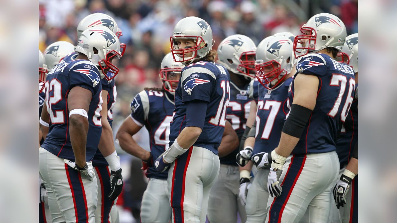 New England Patriots linebacker Tedy Bruschi and quarterback Tom Brady  watch the team warmups prior to their game against the New York Jets at  Gillette Stadium in Foxboro, MA on December 4