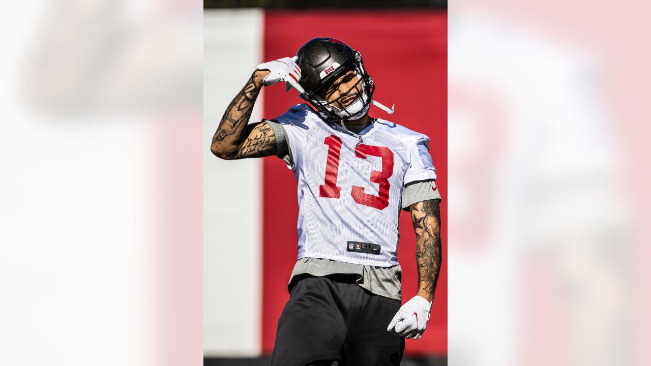 Tampa Bay Buccaneers wide receiver Mike Evans (13) interacts with teammates Tampa  Bay Buccaneers offensive tackle Donovan Smith (76) and Tampa Bay Buccaneers  offensive guard Alex Cappa (65) between plays against the