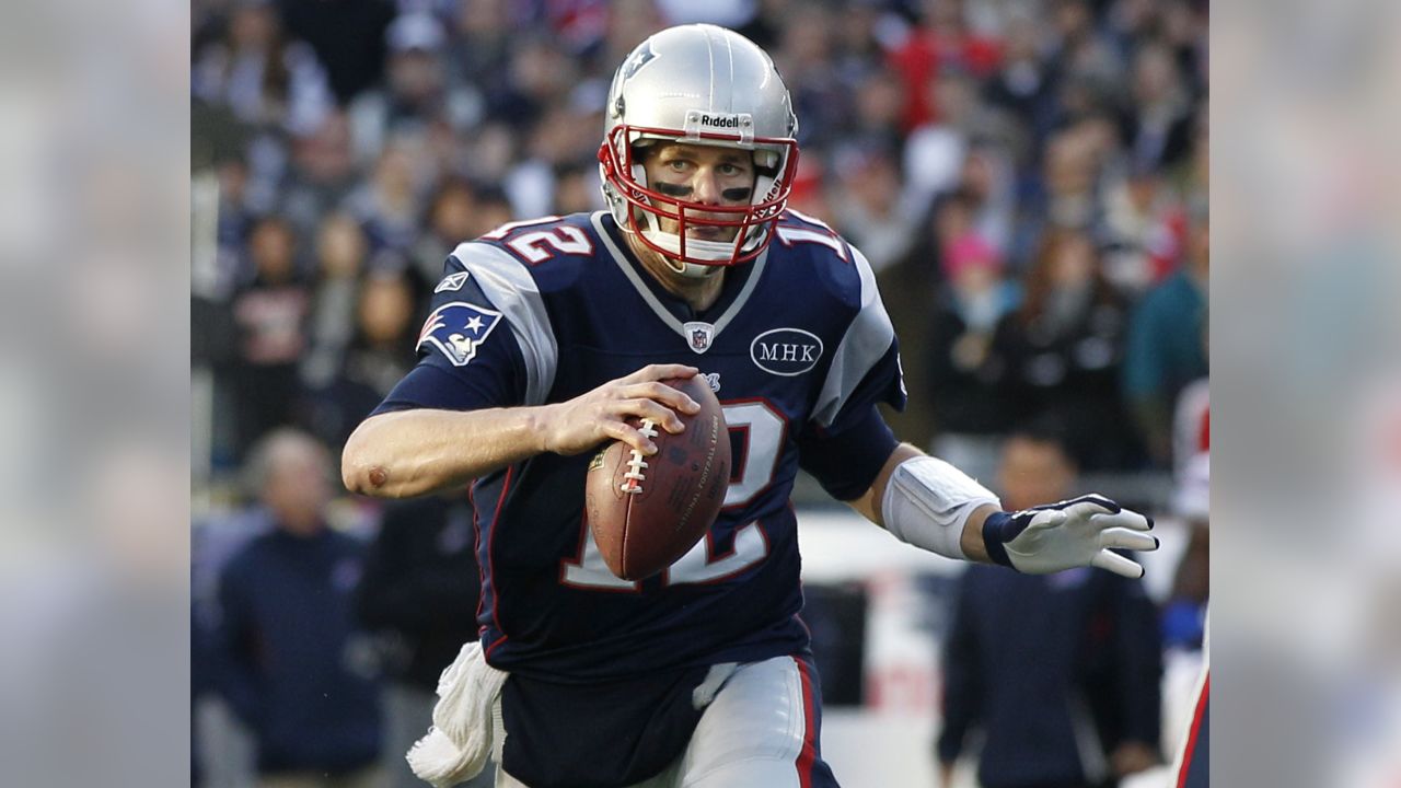 New England Patriots linebacker Tedy Bruschi and quarterback Tom Brady  watch the team warmups prior to their game against the New York Jets at  Gillette Stadium in Foxboro, MA on December 4