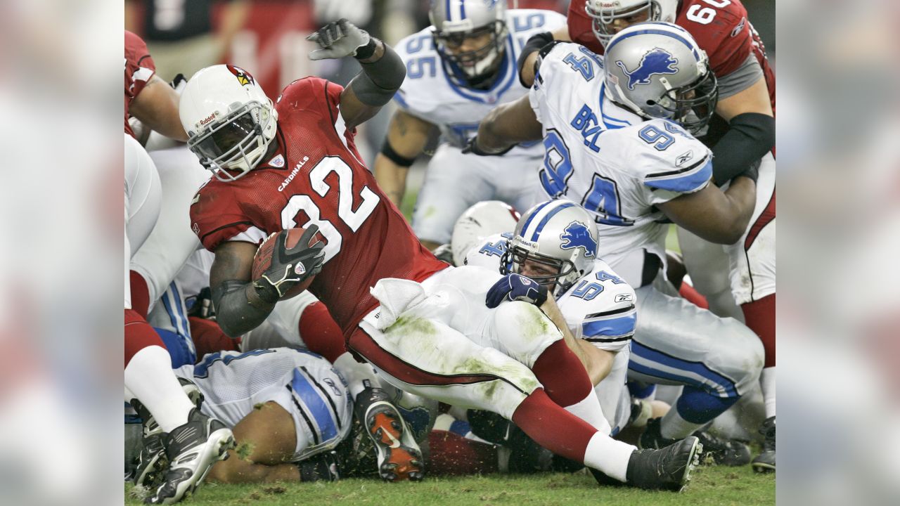 Arizona Cardinals' Fred Wakefield (87) and Detroit Lions Ernie Sims (80)  are separated by line judge Ron Marinucci during the second quarter of  their football game Sunday, Nov. 19, 2006, in Glendale