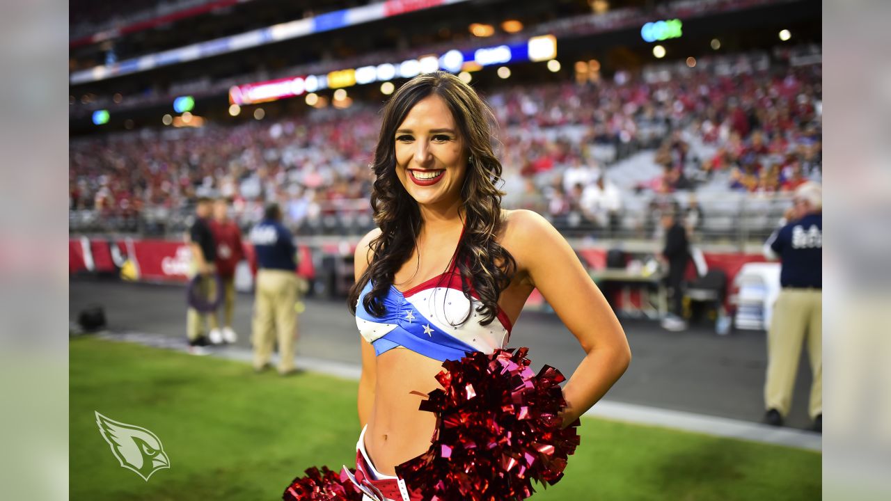 Arizona Cardinals cheerleader strikes a pose during a routine at