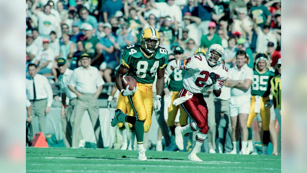 Green Bay Packers wide receiver Sterling Sharpe (84) heads for the end zone  after pulling in a 30-yard Brett Favre touchdown pass during the Packers  game with the Tampa Bay Buccaneers Oct.