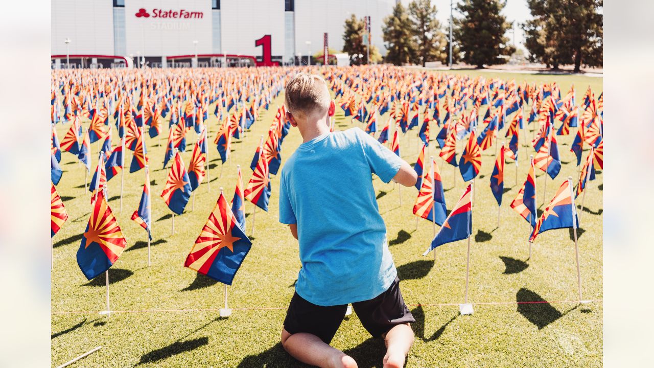 Arizona flags arranged at State Farm Stadium for lives lost to