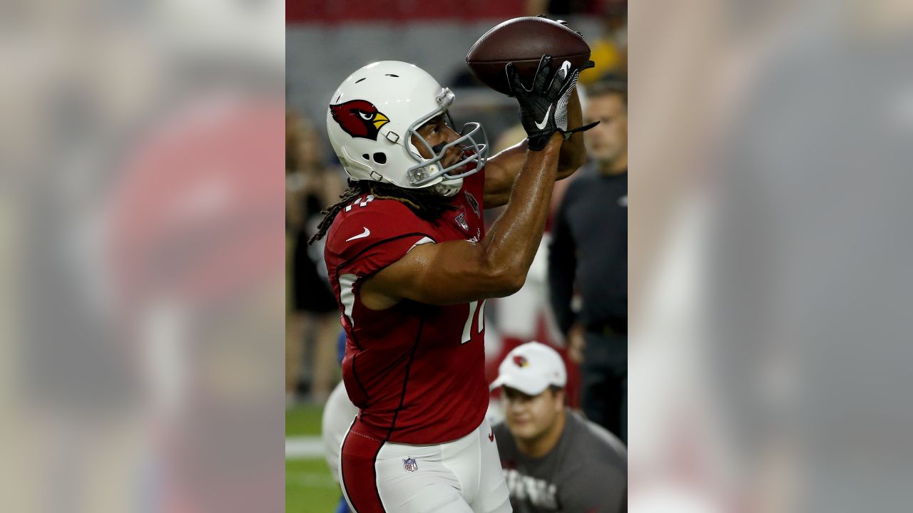 Arizona Cardinals wide receiver Larry Fitzgerald warms up as the Cardinals  NFL football team players get ready to run sprints at State Farm Stadium  Wednesday, July 24, 2019, in Glendale, Ariz. (AP