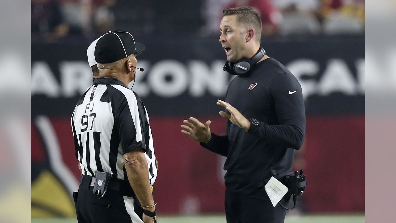 Referee Adrian Hill (29) watches a replay screen during an NFL