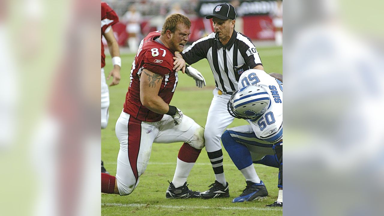 Arizona Cardinals' Fred Wakefield (87) and Detroit Lions Ernie Sims (80)  are separated by line judge Ron Marinucci during the second quarter of  their football game Sunday, Nov. 19, 2006, in Glendale