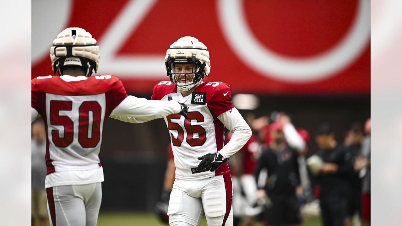 Arizona Cardinals' Will Hernandez (76) and J.J. Watt (99) walk off