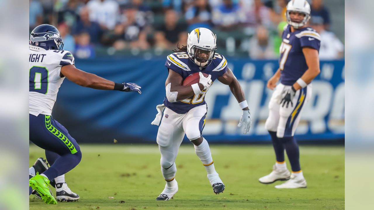 Seattle Seahawks wide receiver Jaron Brown (18) is stopped by Los Angeles  Chargers defensive back Brandon Facyson (28) after a catch during the first  half of an NFL preseason football game in