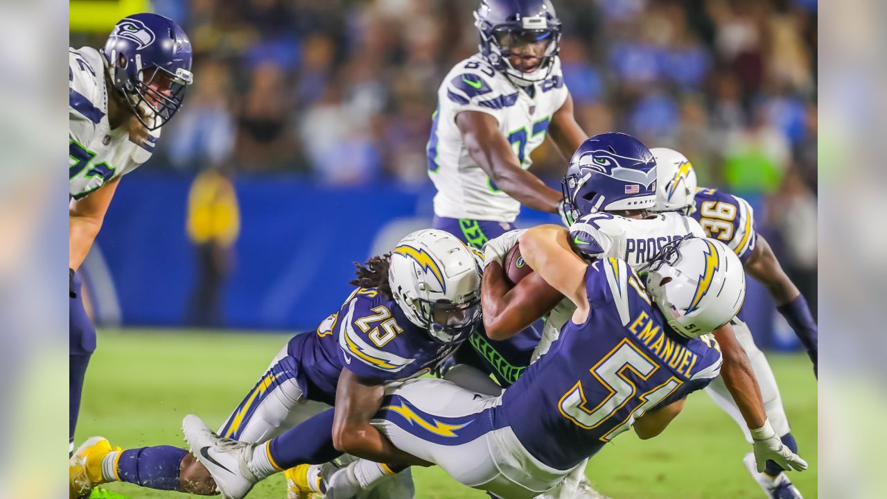 Seattle Seahawks wide receiver Jaron Brown (18) is stopped by Los Angeles  Chargers defensive back Brandon Facyson (28) after a catch during the first  half of an NFL preseason football game in