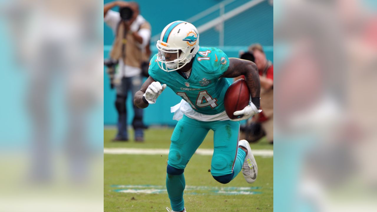 Miami Dolphins running back Ricky Williams (34) rushes for 7 yards in  second quarter action against the Baltimore Ravens in the NFL AFC wildcard  game at Dolphin Stadium in Miami on January