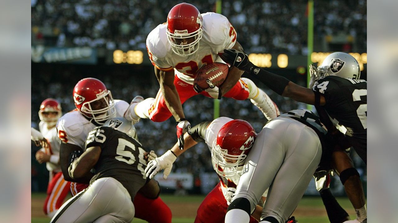 Kansas City Chiefs' running back Marcus Allen crosses the goal line for a  third quarter touchdown as Los Angeles Raiders' Eddie Anderson tries to  stop him in Los Angeles, Nov. 14, 1993.