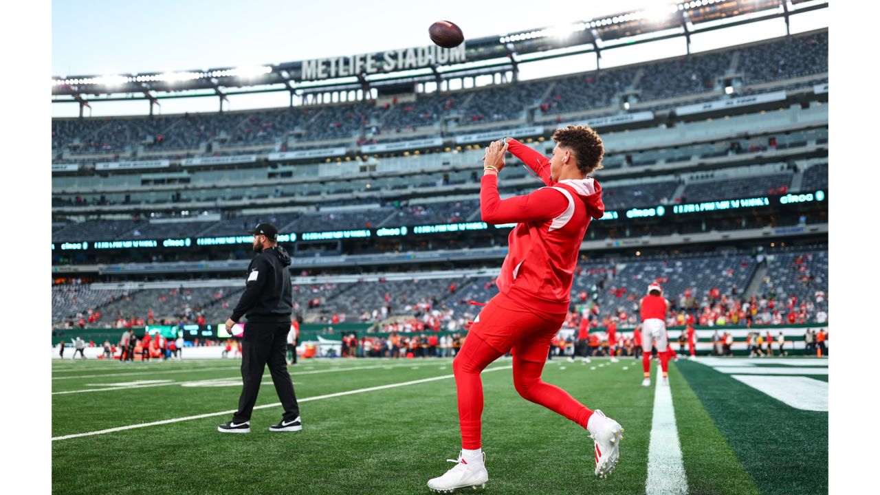 Kansas City Chiefs tight end Travis Kelce (87) and Kansas City Chiefs  linebacker Leo Chenal (54) greet each other during warmups before an NFL  divisional round playoff football game against the Jacksonville