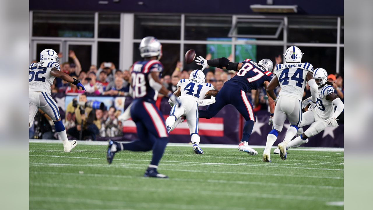 UPDATES TO INTERCEPTION, INSTEAD OF FUMBLE – Indianapolis Colts defensive  back Matthias Farley (41) and New England Patriots tight end Rob Gronkowski  (87) compete for a pass during the second half …