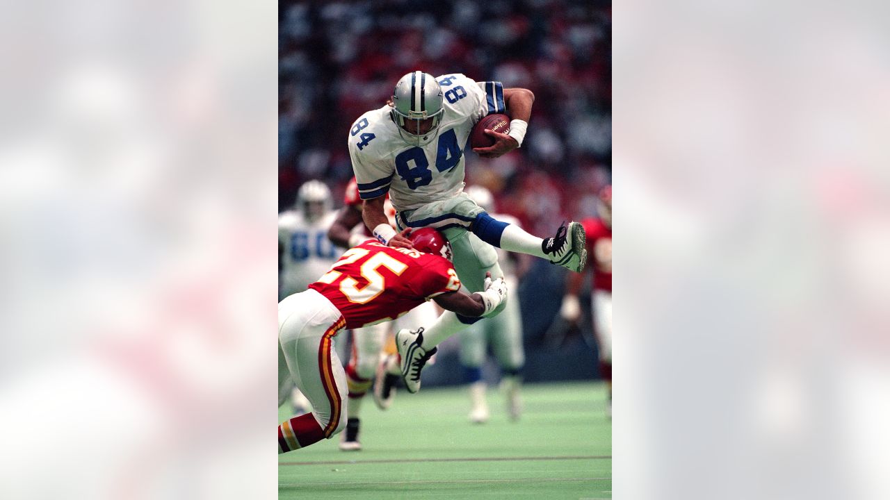 Emmitt Smith of the Dallas Cowboys with the ball jumps over Rickey