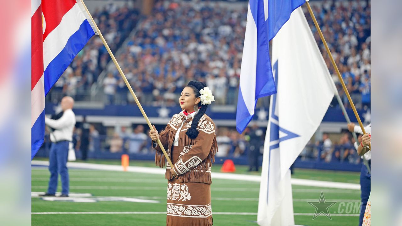 Dancers hold flags of nations of hispanic heritage honoring Hispanic  Heritage Month prior to a NFL football game between the Miami Dolphins and  Dallas Cowboys in Arlington, Texas, Sunday, Sept. 22, 2019. (