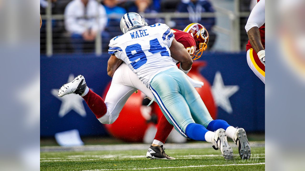 Dallas Cowboys wide receiver Dez Bryant (88) eludes Washington Redskins  defenders to take a Tony Romo pass for 85 yards and a touchdown in the  third quarter at Cowboys Stadium in Arlington