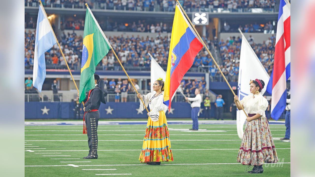 Dancers hold flags of nations of hispanic heritage honoring Hispanic  Heritage Month prior to a NFL football game between the Miami Dolphins and  Dallas Cowboys in Arlington, Texas, Sunday, Sept. 22, 2019. (