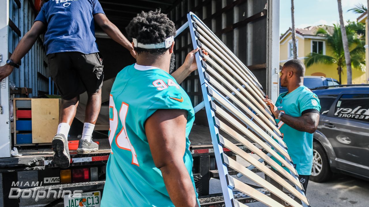 Miami Dolphins defensive players and Ashley HomeStore Deliver Beds