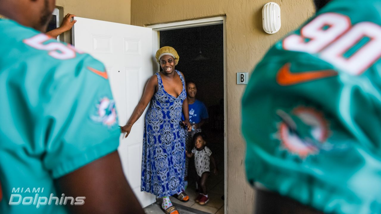 Miami Dolphins defensive players and Ashley HomeStore Deliver Beds